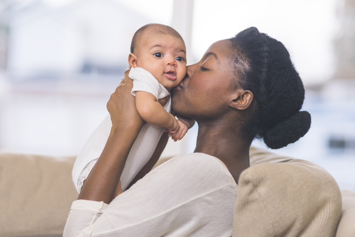 mom kissing baby