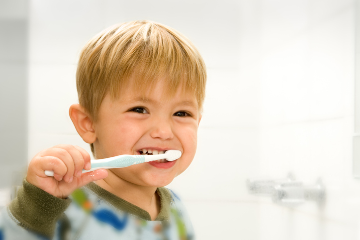 child brushing teeth