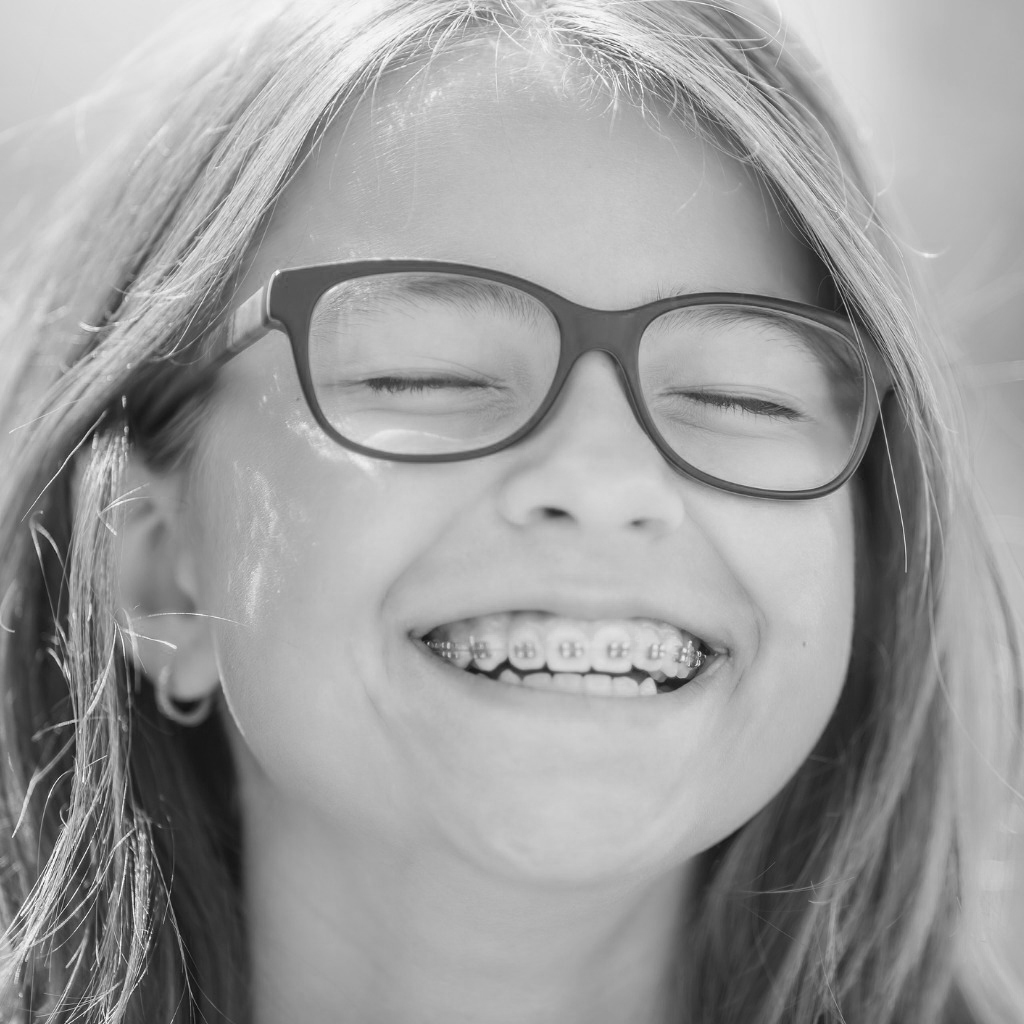 portrait of a happy smiling teenage girl with dental braces and picture id1050261022