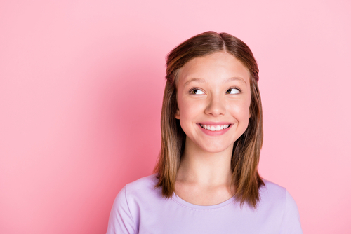 little girl look empty space wonder smile isolated on pastel pink color background