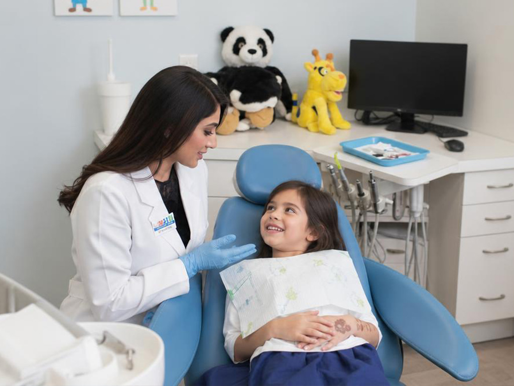 white spot happy patient Dr. Rima with a school-age patient at 800A Fifth Avenue, Suite 303